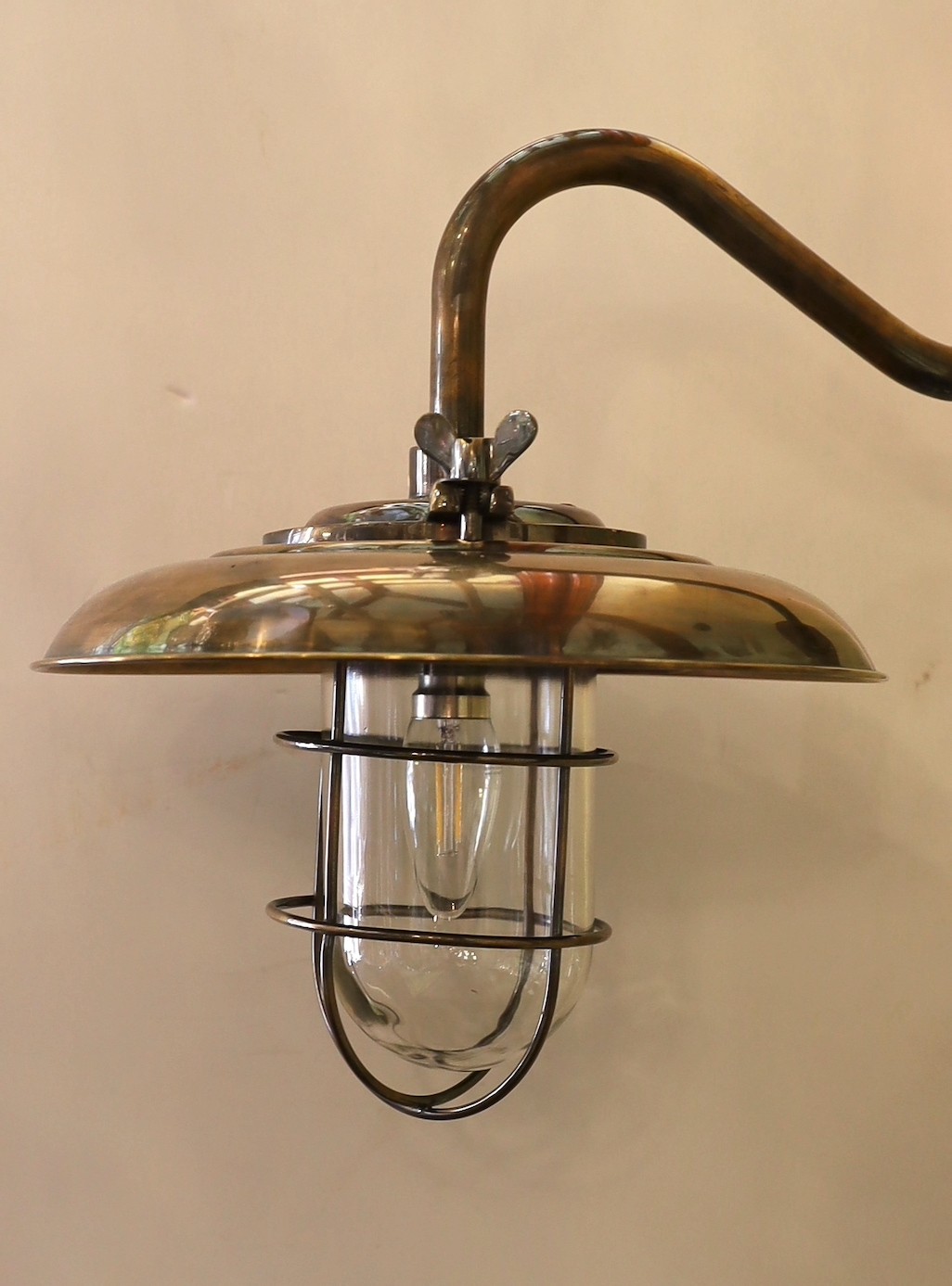 A pair of nautical style bronzed metal wall lights, height 35cm. diameter 35cm